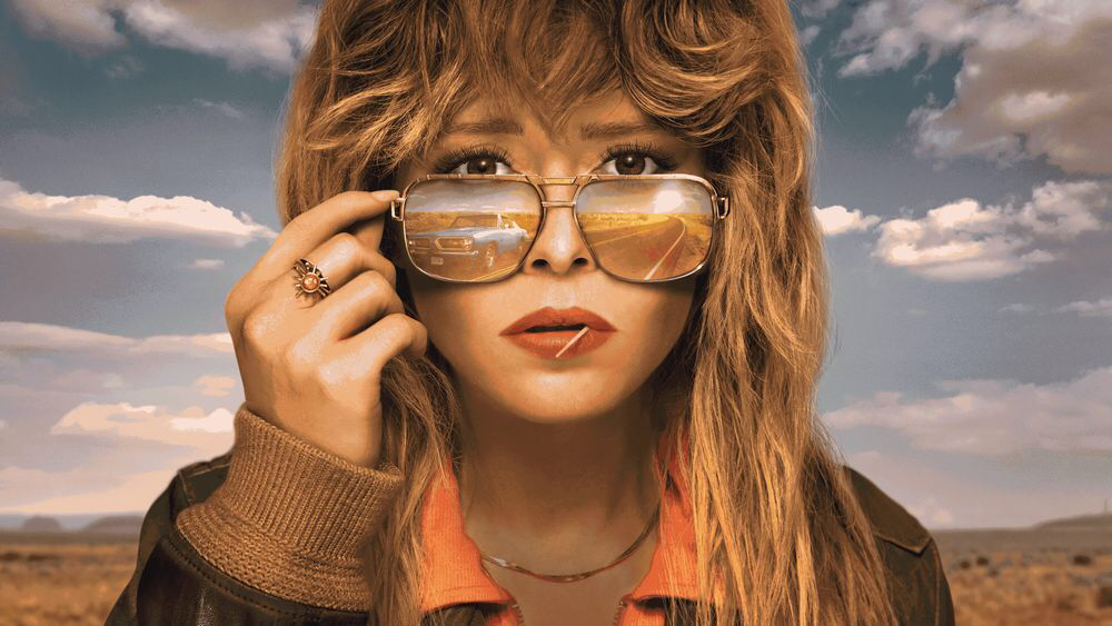 Poster image of Natasha Lynne wearing sunglasses in the American Southwest